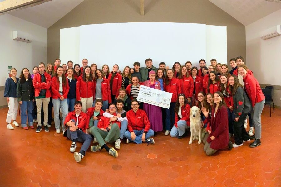 Les étudiants de la 74e Nuit de l'Institut entourent la bénévole Axelle Marnat, qui tient le chèque de 30000 € (fac-similé en grand format)