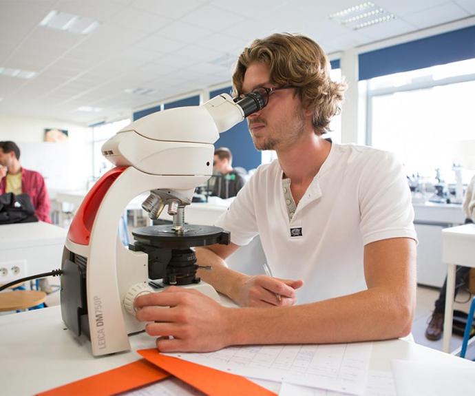 élève-ingénieur en géologie d'UnilaSalle étudiant une lame mince au microscope